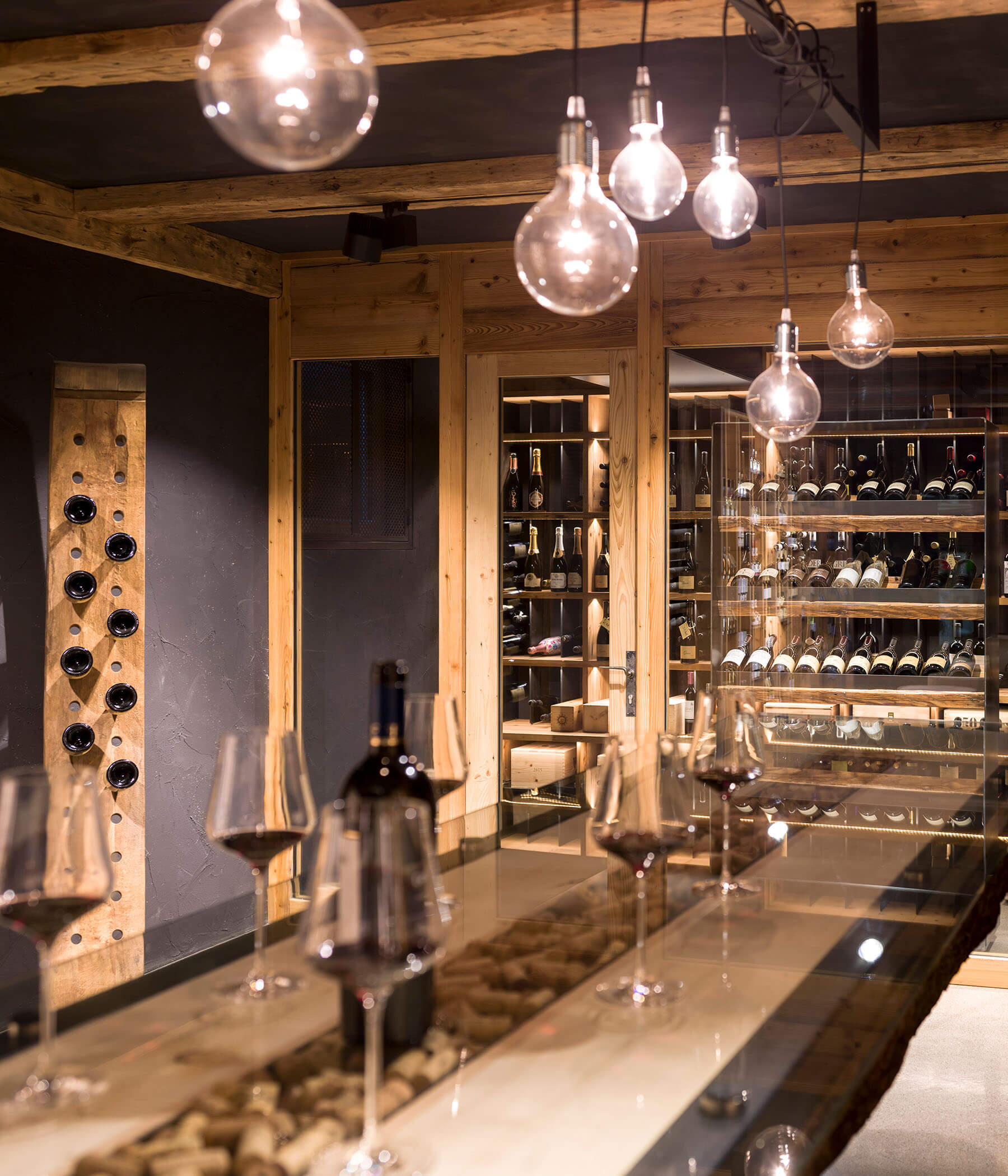 Wine cellar with glasses of red wine on the table